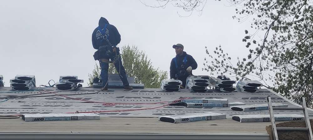 A Roofer Installing Roofing Material on a Residential Roof